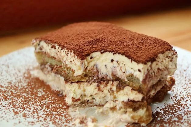 bigstock-closeup-of-a-slice-of-tiramisu-460779691-1
