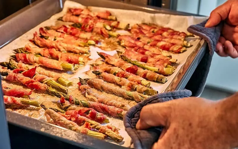 bigstock-man-preparing-young-green-aspa-459701353931045