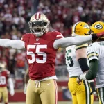 NFC Championship Packers 49ers Football: San Francisco 49ers defensive end Dee Ford (55) gestures next to Green Bay Packers quarterback Aaron Rodgers (12) during the first half of the NFL NFC Championship football game Sunday, Jan. 19, 2020, in Santa Clara, Calif. (AP Photo/Tony Avelar)
