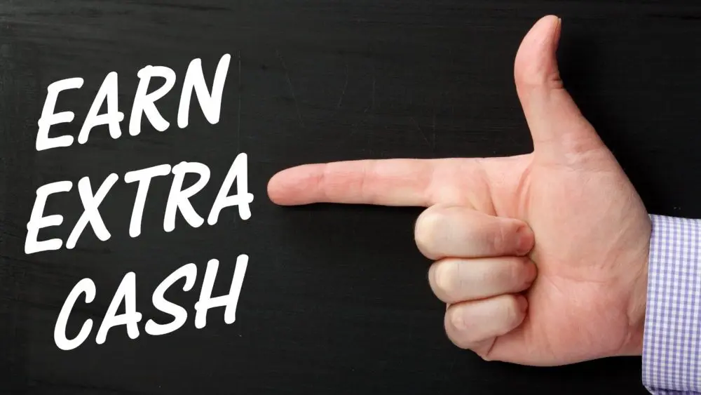 malehandpointingafingeratthephraseearnextra-2