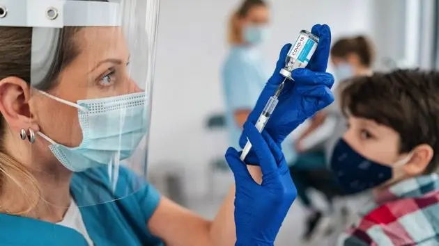 doctor-vaccinating-boy-injecting-covid-19-vaccine-into-patients-arm