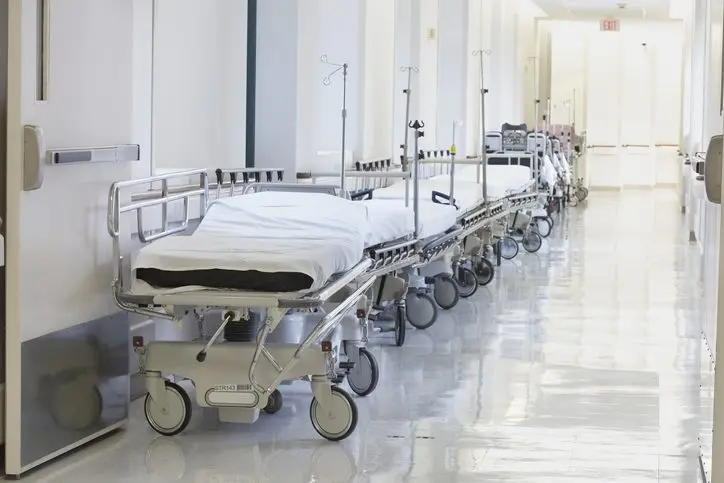 row-of-empty-beds-in-hospital-corridor