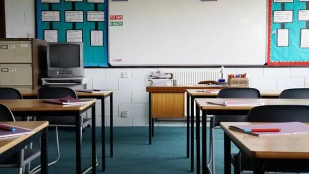 empty-school-classroom-exercise-books-and-pens-on-table