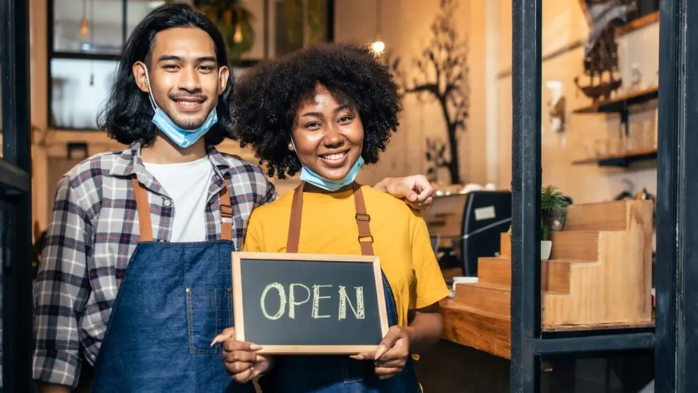 youngcoupleasianmanandafricanwomanmanagerinrestaurant