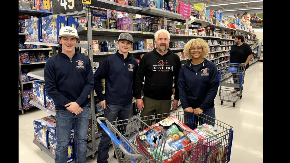 guy-fieri-center-right-and-volunteers-collecting-presents-at-the-windsor-walmart-12-5-23-guy-fieri-foundation