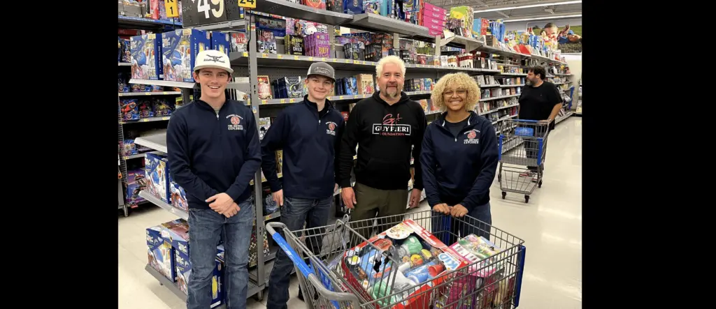 guy-fieri-center-right-and-volunteers-collecting-presents-at-the-windsor-walmart-12-5-23-guy-fieri-foundation