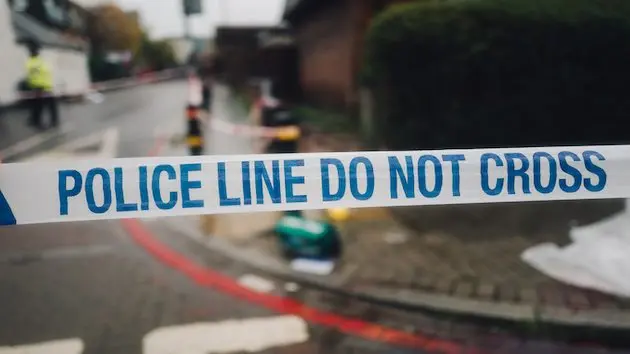 police-white-and-blue-cordon-tape-separating-the-crime-scene