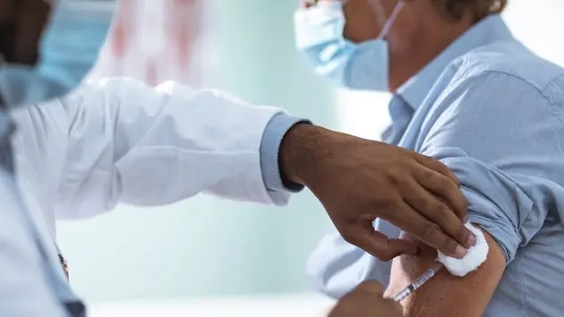 mature-man-taking-a-vaccine-from-his-doctor