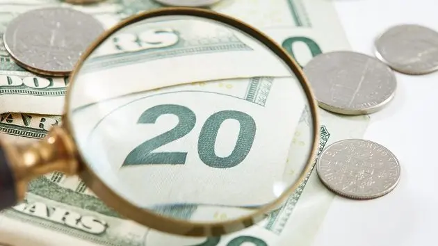 close-up-on-a-twenty-dollar-bill-under-a-magnifying-glass