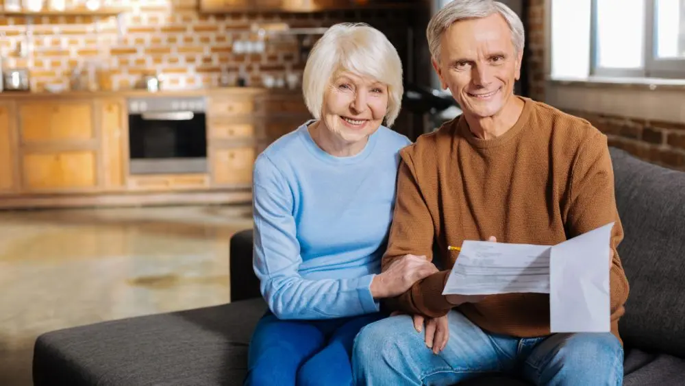 happyrelationships-joyfulpositiveelderlycouplesittingtogetherandsmiling