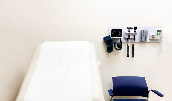 access-to-medical-care-wall-mounted-medical-diagnostic-equipment-beside-standard-patient-examination-chair