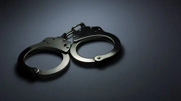 close-up-of-handcuffs-over-gray-background