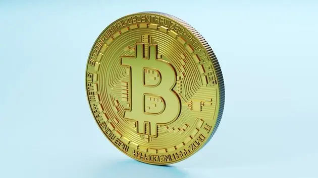 three-dimensional-render-of-bitcoin-standing-against-blue-background
