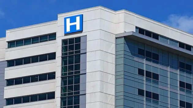 large-modern-building-with-blue-letter-h-sign-for-hospital