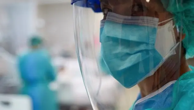 close-up-view-of-a-docotr-wearing-surgical-mask-and-a-face-shield
