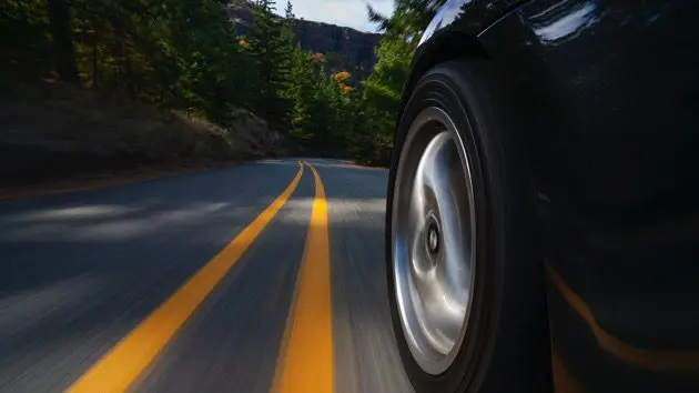 black-sports-car-motion-country-road