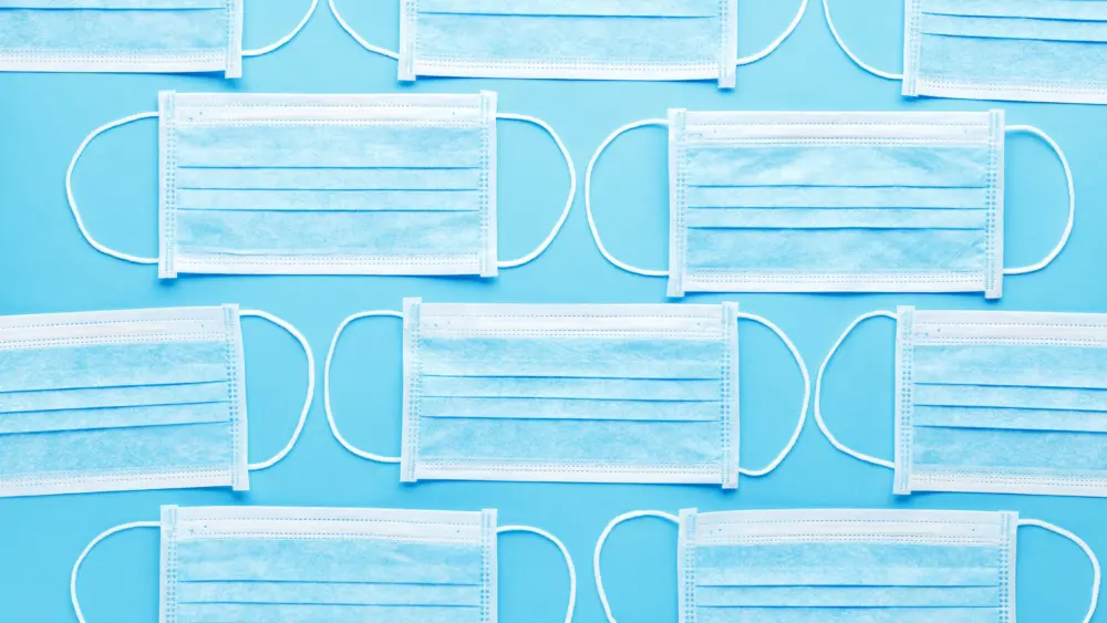 medicalhygienicmaskfaceprotectivemasksonbluebackground-disposablesurgical
