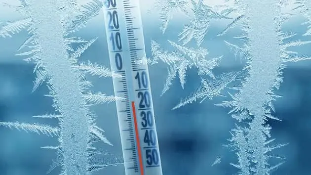 frosty-winter-window-with-ice-patterns-and-a-thermometer-showing-a-minus-temperature