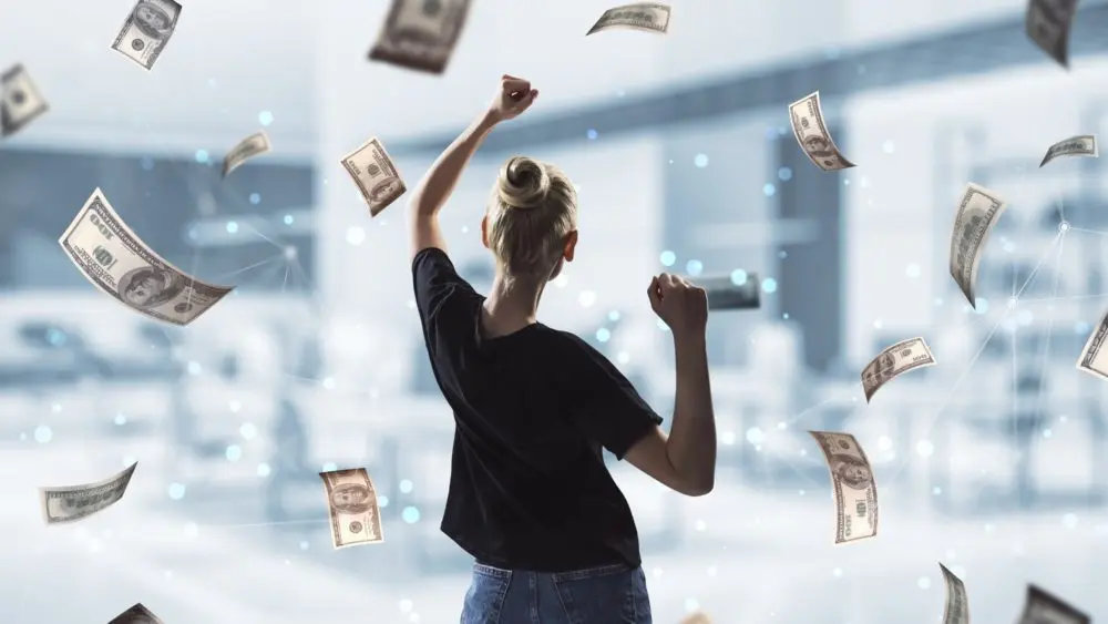 backviewofoungsuccessfulwomanwithdollarbillmoney
