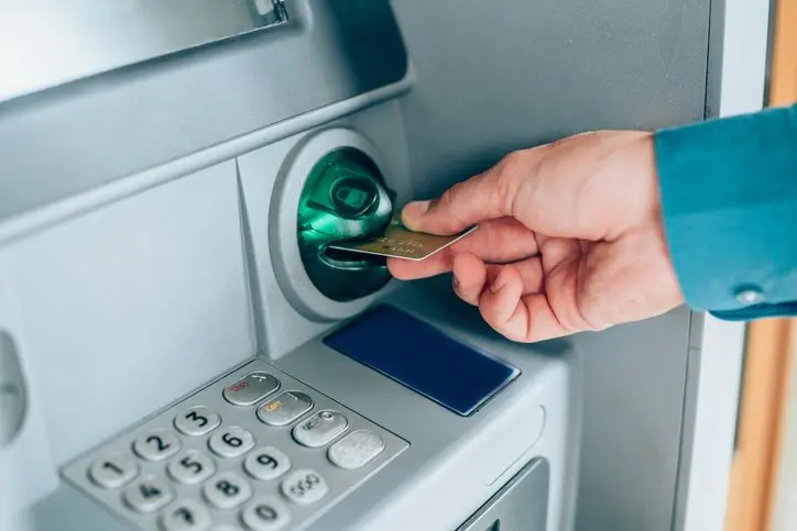 man-is-withdrawing-money-from-an-atm