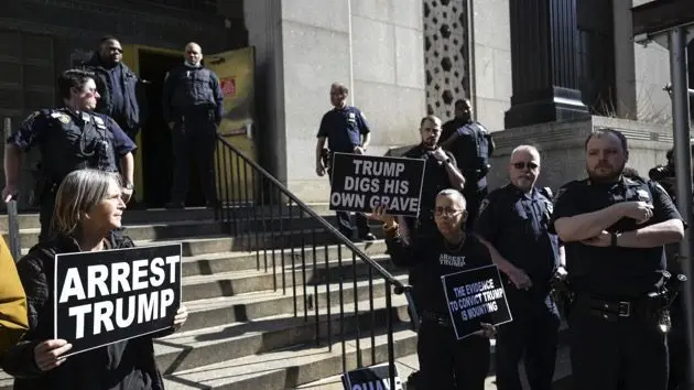 protestors-hold-signs-outside-the-manhattan-district-attorneys-office-2