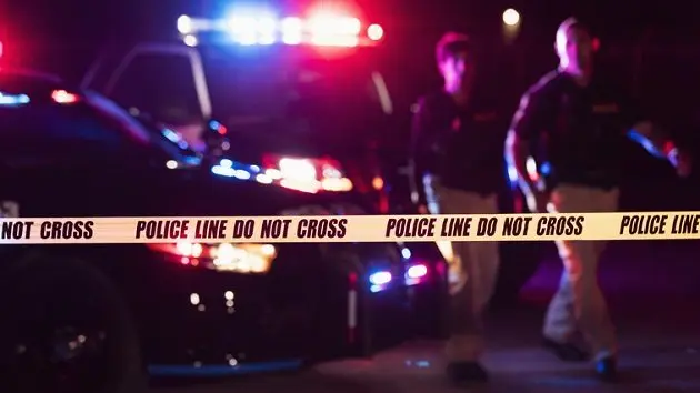 two-police-officers-behind-crime-scene-tape-2