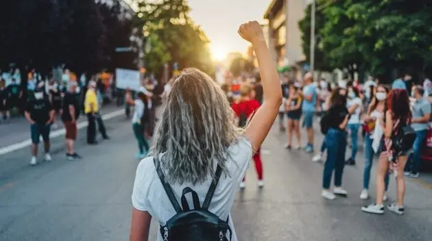 young-woman-protester-raising-her-fist-up