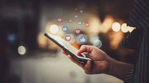 hand-using-smartphone-with-social-media-concept