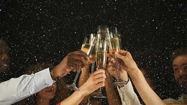 group-of-young-people-celebrating-new-year-with-champagne-at-night-club