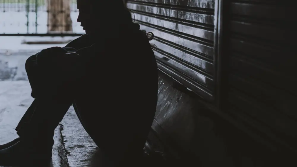 homelesswomansittingonthestreetsidehopeless