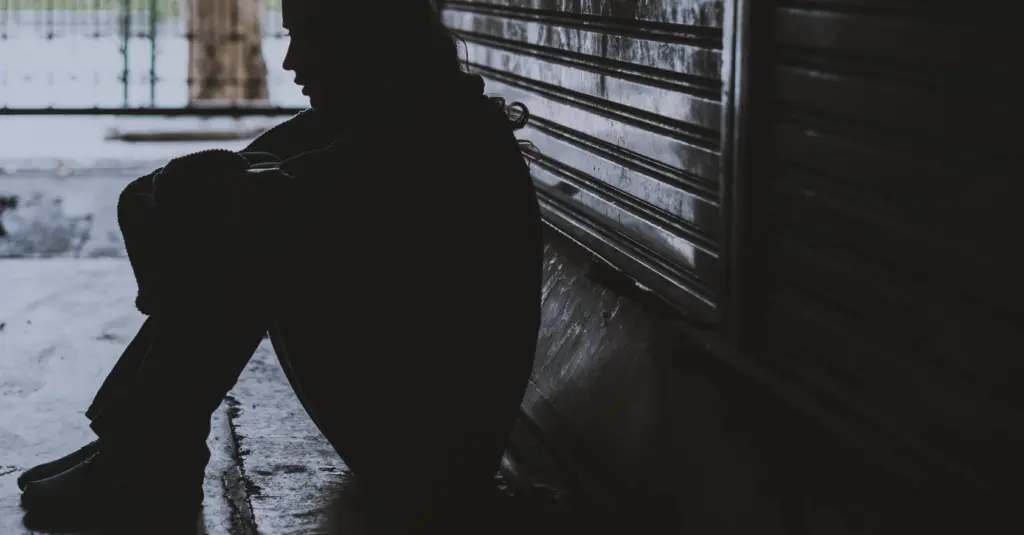 homelesswomansittingonthestreetsidehopeless