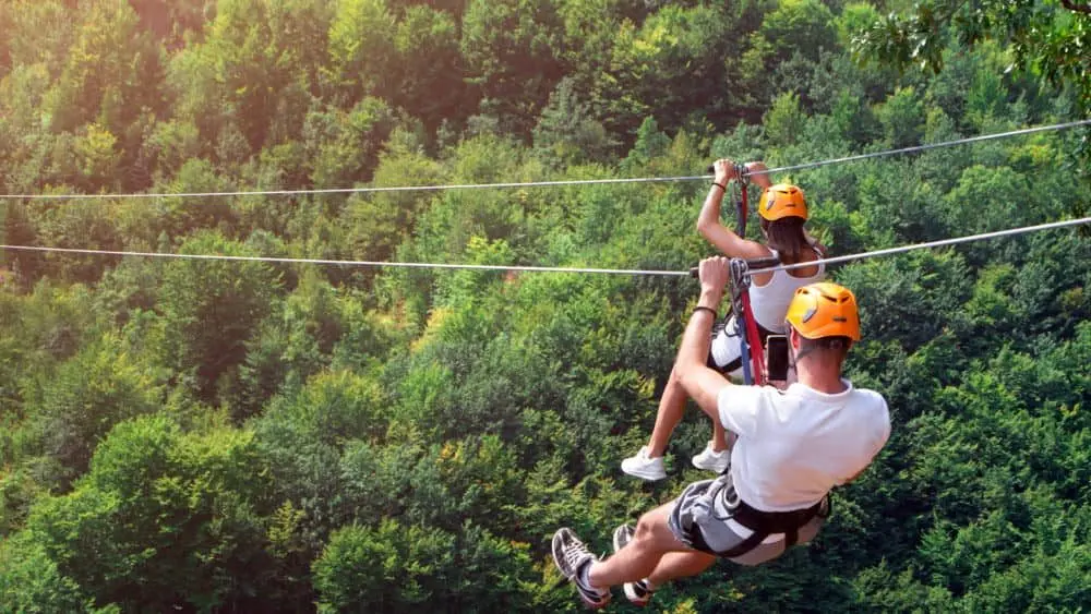 ziplineisanexcitingadventureactivity-manandwomanhanging