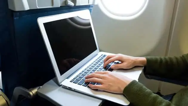 woman-using-laptop-computer-on-airplane