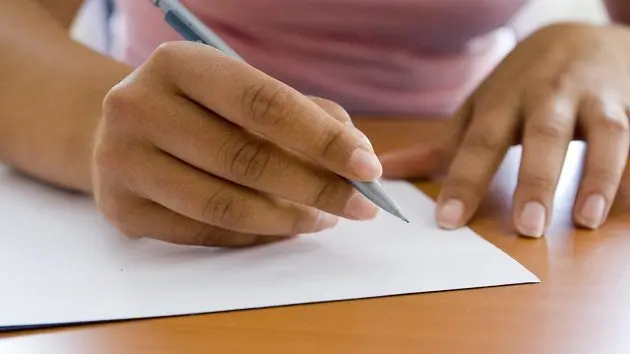 close-up-of-adult-hands-writing-with-pen-and-paper