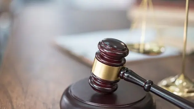 justice-scales-and-books-and-wooden-gavel