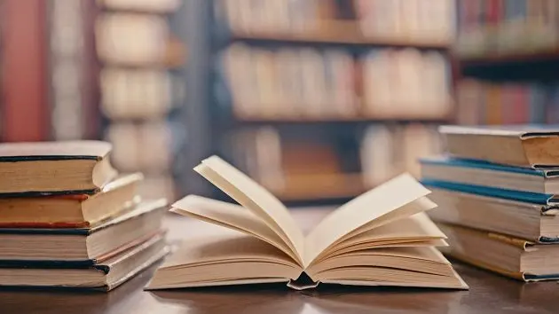 library-books-on-table-and-background-for-studying-learning-and-research-in-education-school-or-college-reading-philosophy-and-open-vintage-or-history-print-book-university-blurred-background