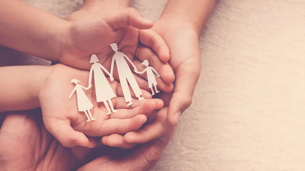 handsholdingpaperfamilycutoutfamilyhomefostercarehomeless