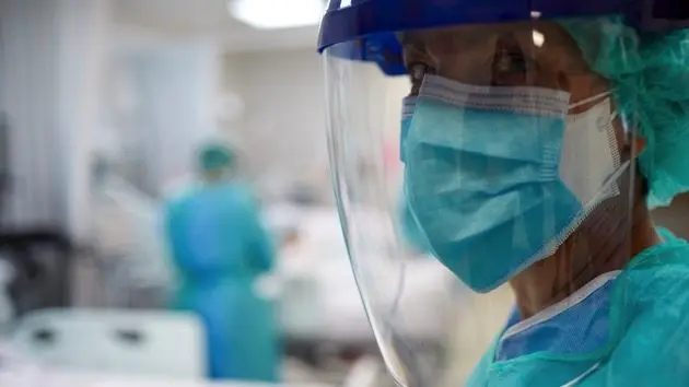 close-up-view-of-a-doctor-wearing-surgical-mask-and-a-face-shield