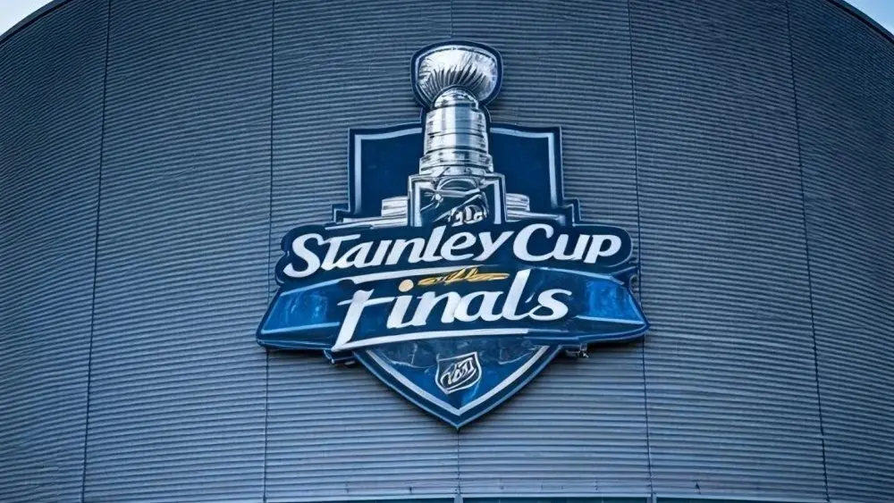 the front facade of a hockey arena with the NHL Stanley Cup Finals logo on the front of the building.