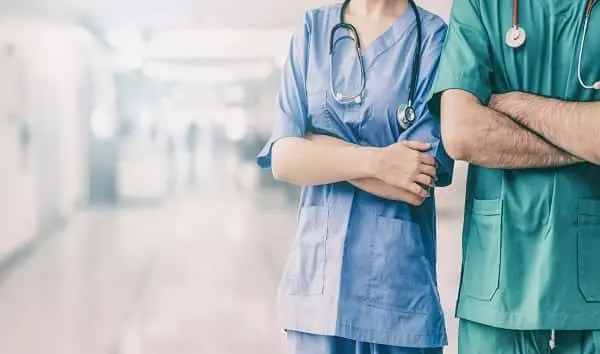 doctor-and-surgeon-with-arms-crossed-in-hospital