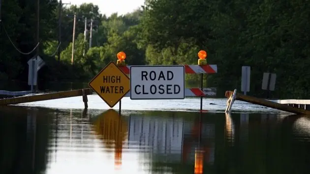 a-road-closure-signage-as-water-covers-the-road