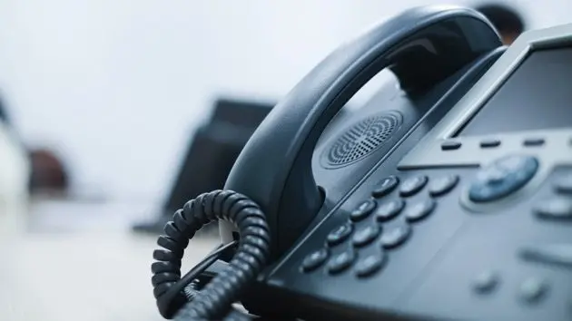 close-up-soft-focus-on-telephone-devices-at-office-desk-for-customer-service-support-concept
