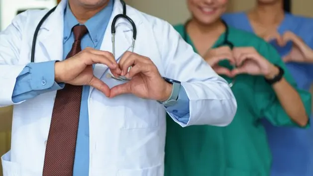 medicine-people-charity-health-care-and-cardiology-concept-doctors-hands-making-heart-shape
