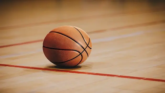 classic-basketball-on-wooden-court-floor-close-up-with-blurred-arena-in-background-orange-ball-on-a-hardwood-basketball-court-2