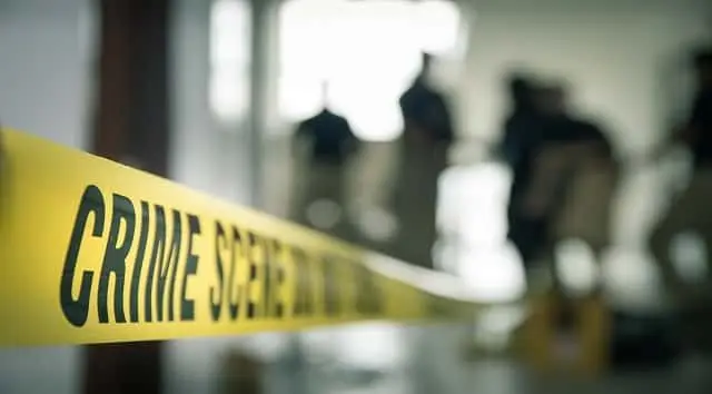 crime-scene-tape-with-blurred-forensic-in-cinematic-tone