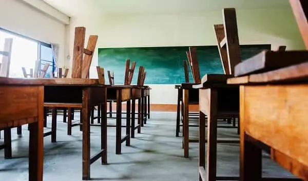 chair-and-table-in-class-room-with-black-board-background-no-student-school-closed-concept