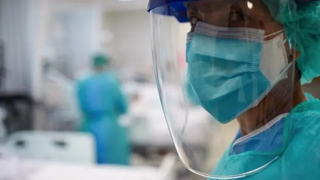 close-up-view-of-a-doctor-wearing-surgical-mask-and-a-face-shield