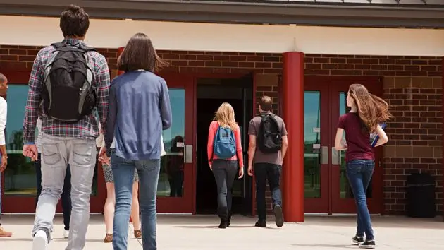 high-school-students-entering-school-building