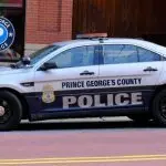 Prince George's County^ Maryland police car sits parked on a street in National Harbor in front of a public parking garage.
