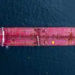 Aerial view crude oil tanker ship at sea^ Red crude oil tanker ship top view^ Logistic and maritime transpoprtation of petroleum^ Modern offshore terminal loading tanker ship.